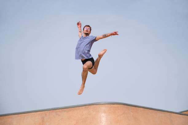 istock Dancer is making a figure jumping very high in a skatepark 2165892711