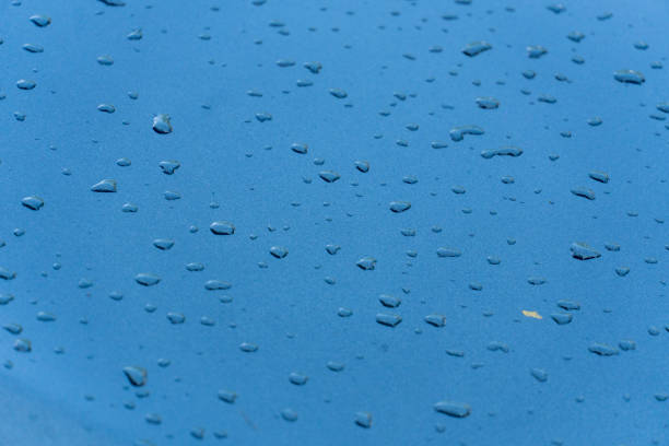 a group of water drops on metallized paint