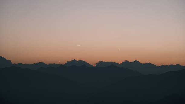 istock Silhouette of mountain ranges during sunset with a gradient sky. 2165897629