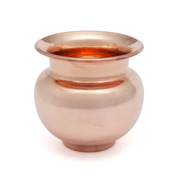 istock A copper 'Kalash' (lota), a traditional globular water container, placed on a white background. 2165898629