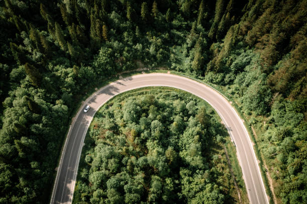 istock Flight over the summer mountains with mountain road serpentine 2165900174