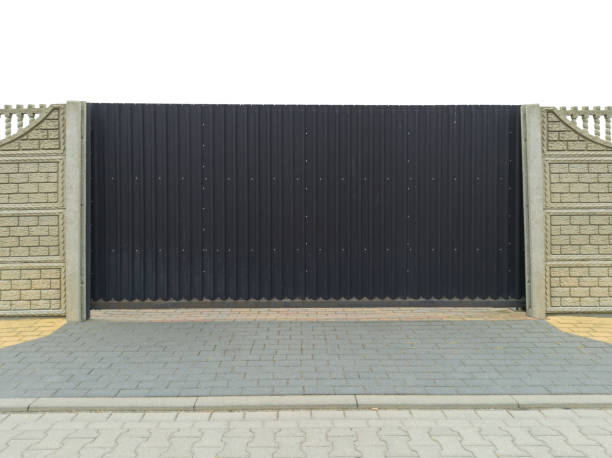 istock Black Metal Gate with Stone Walls 2165900513