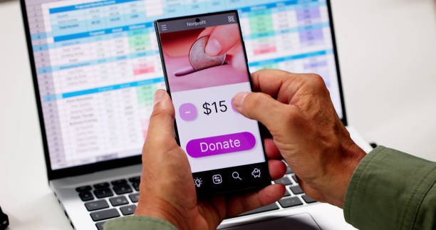 istock Man Using Online Money Donation Mobile Phone 2165903990