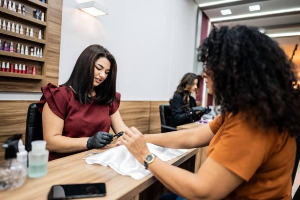 istock Manicure doing customer's nail on a nail salon 2165907141