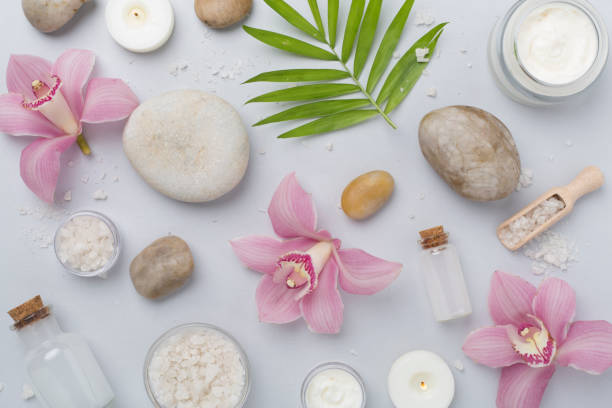 istock Composition with orchids and massage stones on color background, top view 2165908470