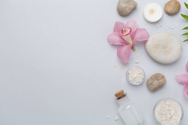 istock Composition with orchids and massage stones on color background, top view 2165908477