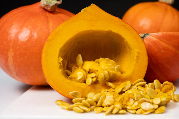 Hokkaido pumpkin seed extraction. Pumpkin inside with raw seeds.