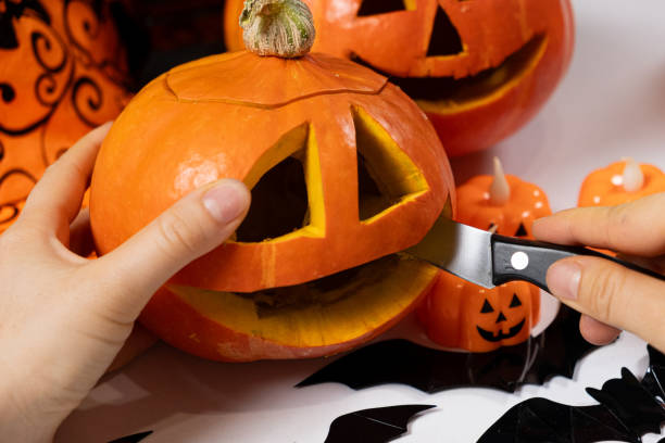 istock Creating a Hokkaido pumpkin jack-o'-lantern for Halloween. 2165910247
