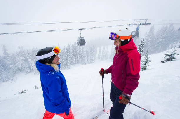 istock Friends pause on ski hill on snowy day 2165910271