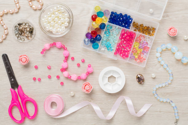istock Tools and beads for making handmade jewelry on wooden background, top view 2165910926