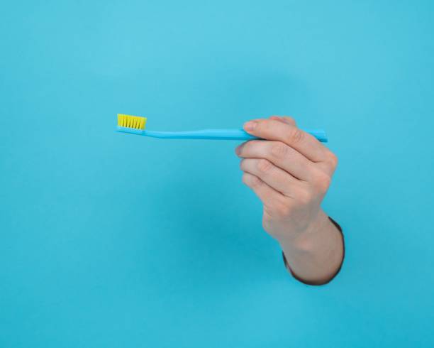 istock Woman holding a blue anal plug on a blue background. 2165911002