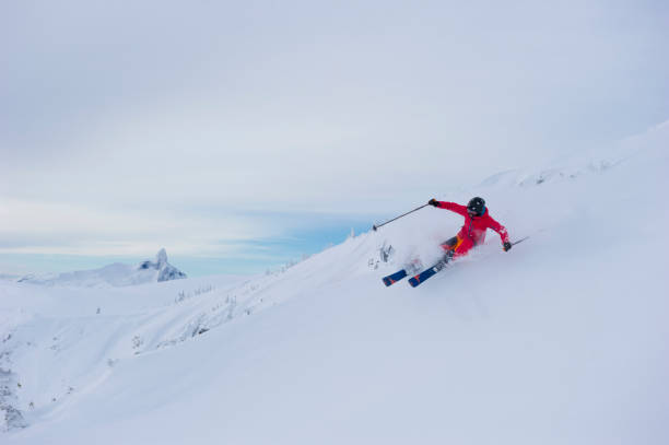 istock Woman skis fresh powder snow 2165911085