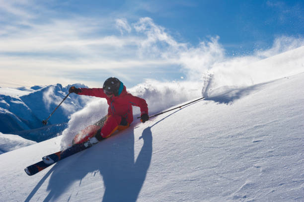 istock Woman skis fresh powder snow 2165911113