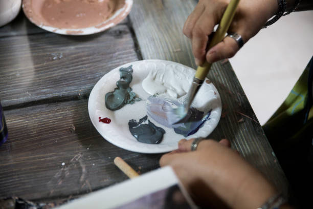 istock Female Painter Mixing Paints In Plate 2165917252