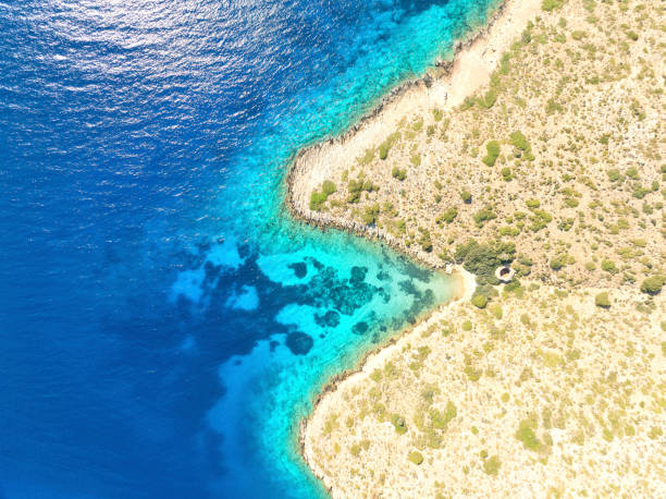 view from above of a small beach in Lipsi, Dodecanese Islands, the photo was taken with a drone and always a mouth that eats something, or expels it.. Lispi Island, Dodecanese islands.