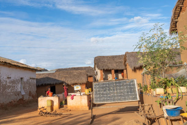 Women in the village, solar cells in front, Madagascar stock photo