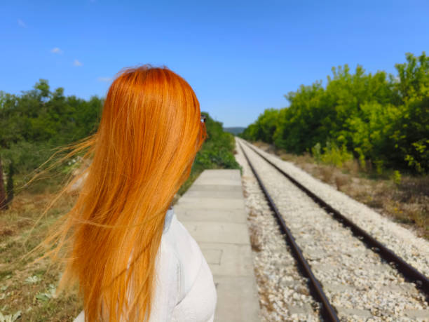 Man leaves, the woman remains alone at the train station