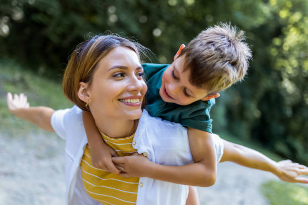 istock Young beautiful mother playing with her son piggy back. 2165929847