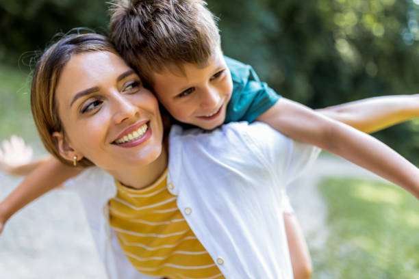istock Young beautiful mother playing with her son piggy back. 2165929849