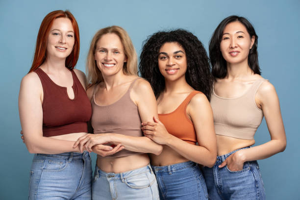 istock Diverse group for multinational smiling women wearing stylish top and tank top, hugging posing 2165935531