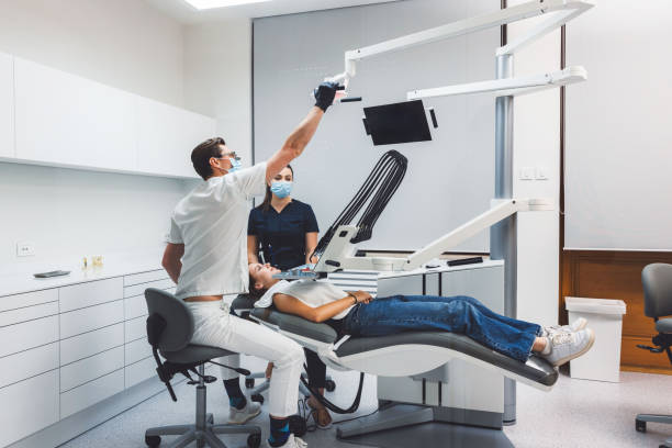 Dentist Performing Procedure in Modern Dental Clinic