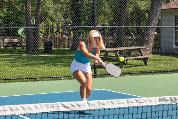istock Female pickleball player returns ball 2165939537