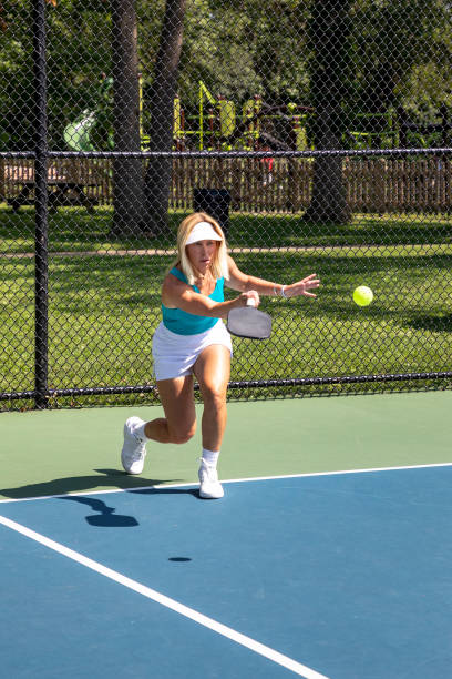 istock Female pickleball player serving 2165939539