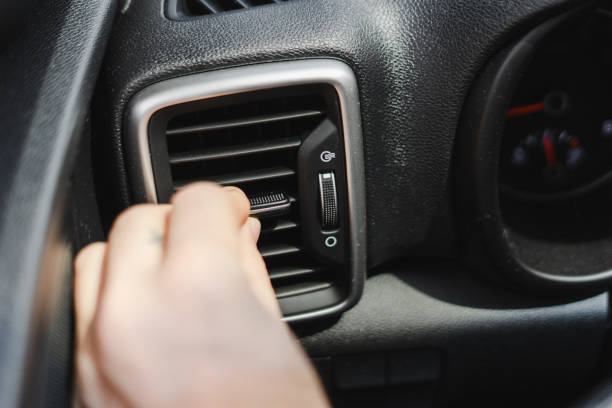 istock Driver adjusting car air conditioning vent for comfort 2165941192