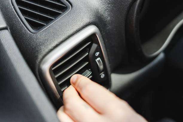 istock Driver adjusting air conditioning ventilation grille inside car 2165941195