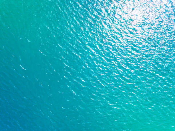 istock Beautiful sea beach and waves texture in sunny summer day background 2165942176