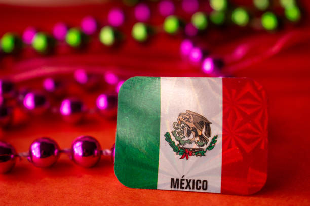 High angle view of Mexican flag and colorful carnival stuff on orange color background