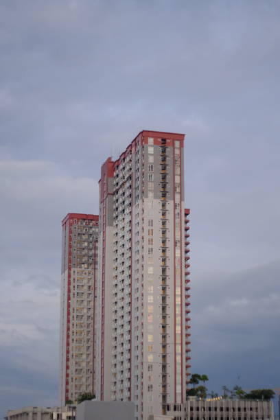A captivating image of a skyscraper towering against a clear, beautiful sky. The photograph showcases the sleek lines and modern architecture of the building, set against the backdrop of a perfect day, emphasizing themes of urban development, modern design, and the harmony between architecture and the natural environment.