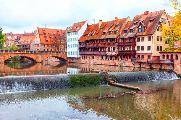 Picturesque river flows through an urban landscape in Nuremberg in Germany, showcasing the harmony between nature and city architecture