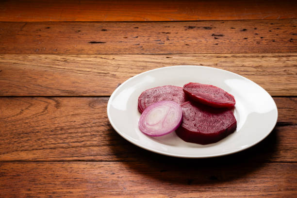 View of plate with beet and  slice of onion  , served as delicious healthy salad for lunch.