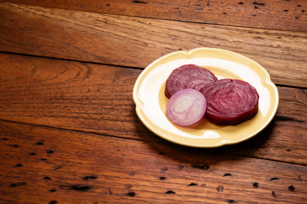 View of plate with beet and  slice of onion  , served as delicious healthy salad for lunch.