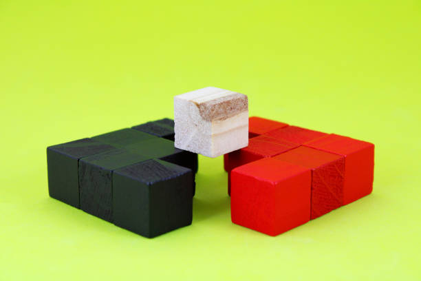 Wooden cube on arrows pointing in opposite directions