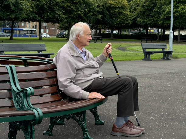Glasgow, UK, August 8th 2024, Elderly man sat alone in public park