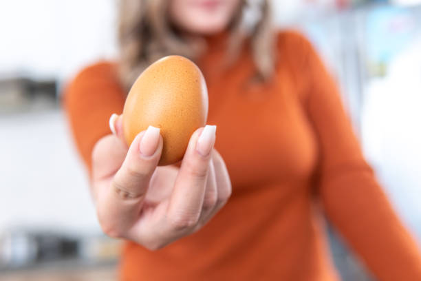 istock closeup of a woman's hand showing an egg 2165950650