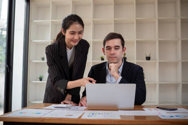 istock Business Colleagues Collaboration on Project in Modern Office with Laptop and Documents 2165953780