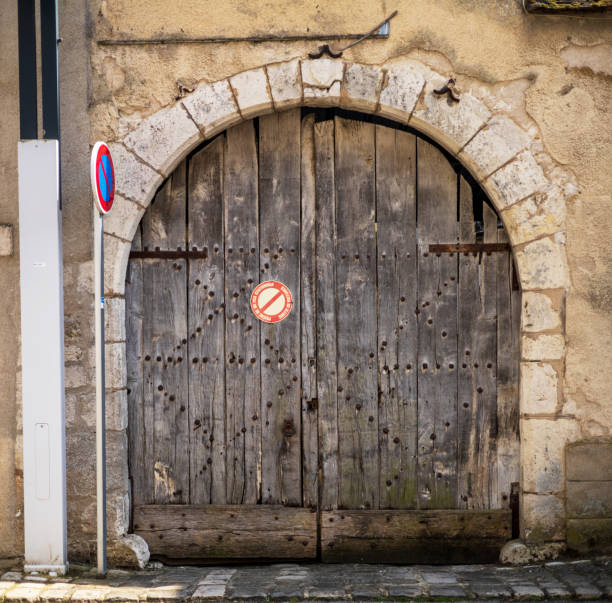 istock Weathered Wooden Door with Stone Arch 2165955266