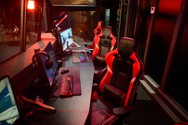 istock Game room interior with modern ambient lights and powerful computers, consoles, keyboards for playing video games. eSport industry. 2165960779