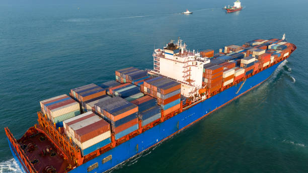 istock stern view Cargo container ship carrying container and running in the ocean near international container port customs shipyard sea port concept smart logistic service. transportation logistics trading. 2165960810