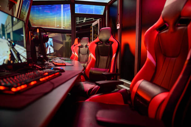istock Game room interior with modern ambient lights and powerful computers, consoles, keyboards for playing video games. eSport industry. 2165960825