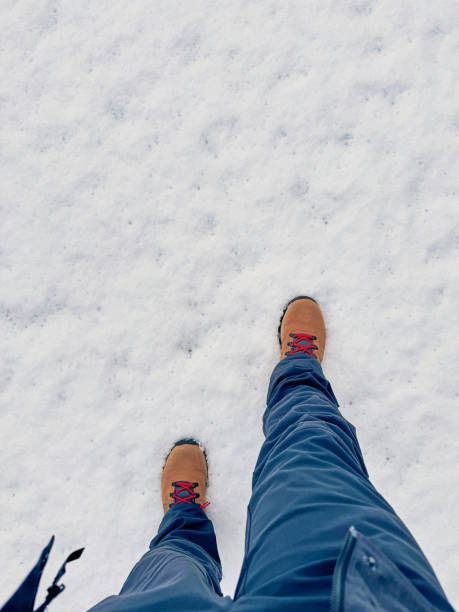 istock Hiker wearing trekking boots walking on snow in winter 2165960873