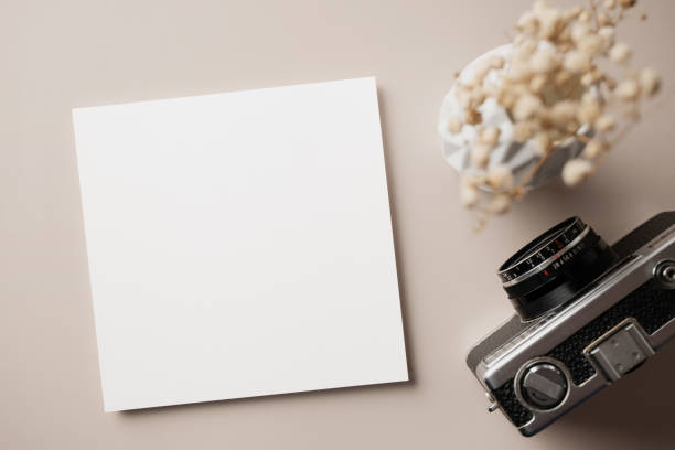 istock White blank greeting or invitation card with ceramic jar decoration and envelope on beige background. Mock up presentation. Flat lay. 2165962299