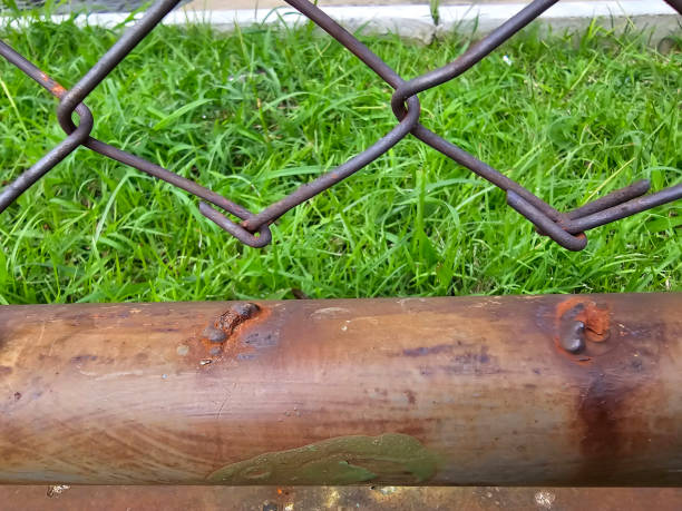 The iron fence has rusted through and is now damaged.