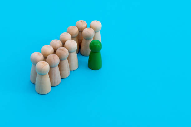Green one standing out from the wooden figures.