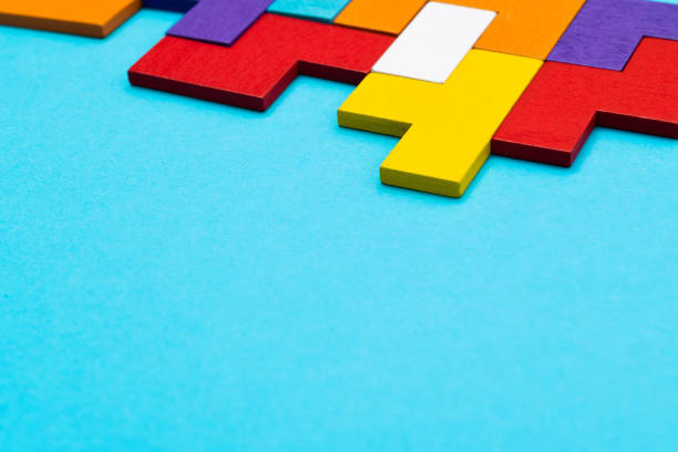 Different colorful shapes wooden blocks on blue background.