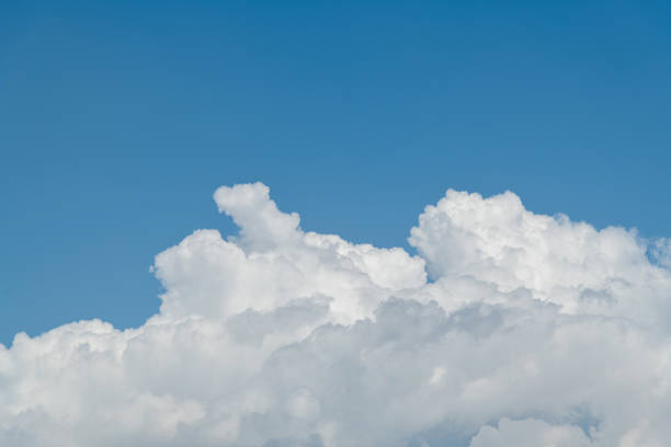 Blue sky with large cumulus cloud.