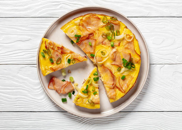 istock deli ham onion omelette on skillet, top view 2165971855